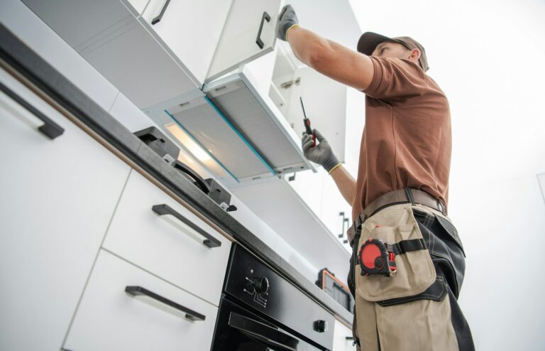 Residential Cabinetmaker Worker Finishing New Kitchen Installation